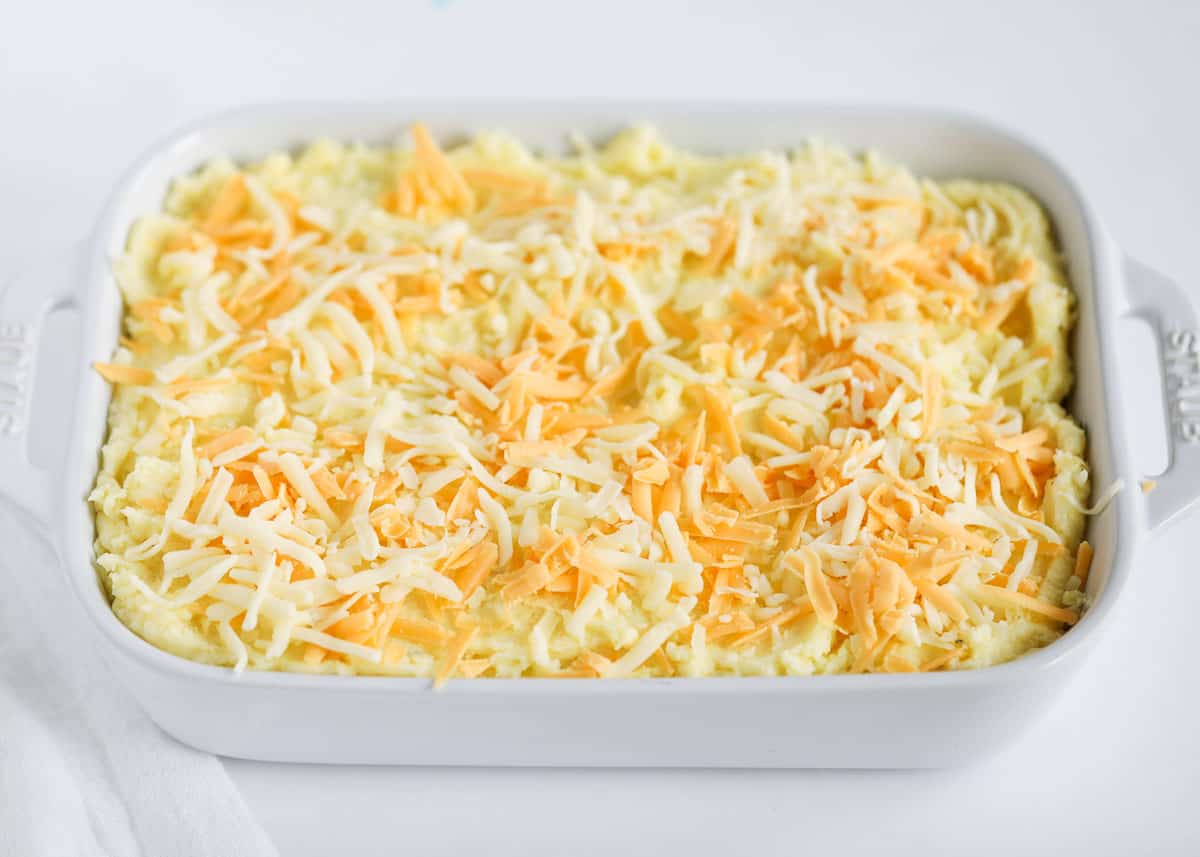 cheese on top of potatoes in baking dish