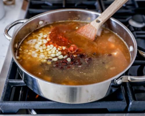 cooking chicken tortilla soup in pot