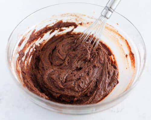 whisking chocolate batter in glass bowl