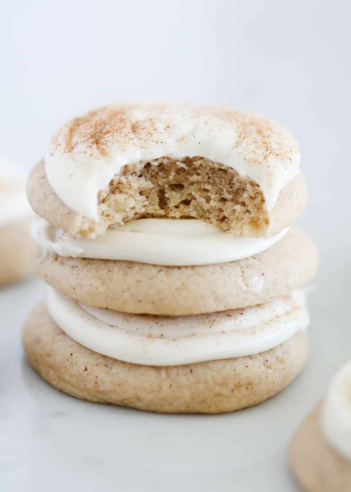 Stacked cinnamon roll cookies on counter.