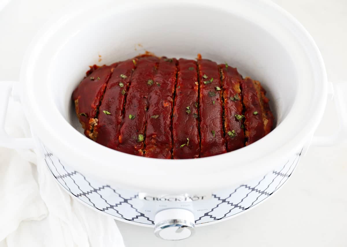 Crockpot turkey meatloaf is made with just 10 minutes of prep time and ready for you when you walk in the door. Don't let this delicious, no-fuss, comfort food classic fool you, it's perfect for serving guests too! sliced turkey meatloaf in crockpot