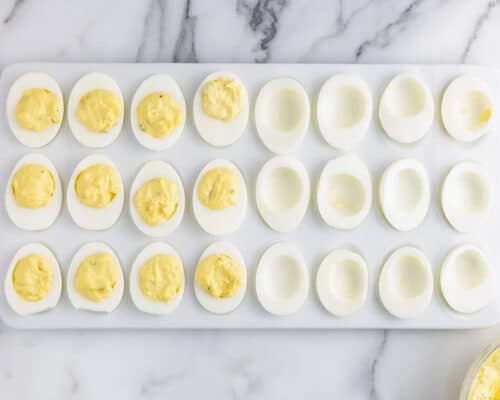 deviled eggs cut in half on white plate