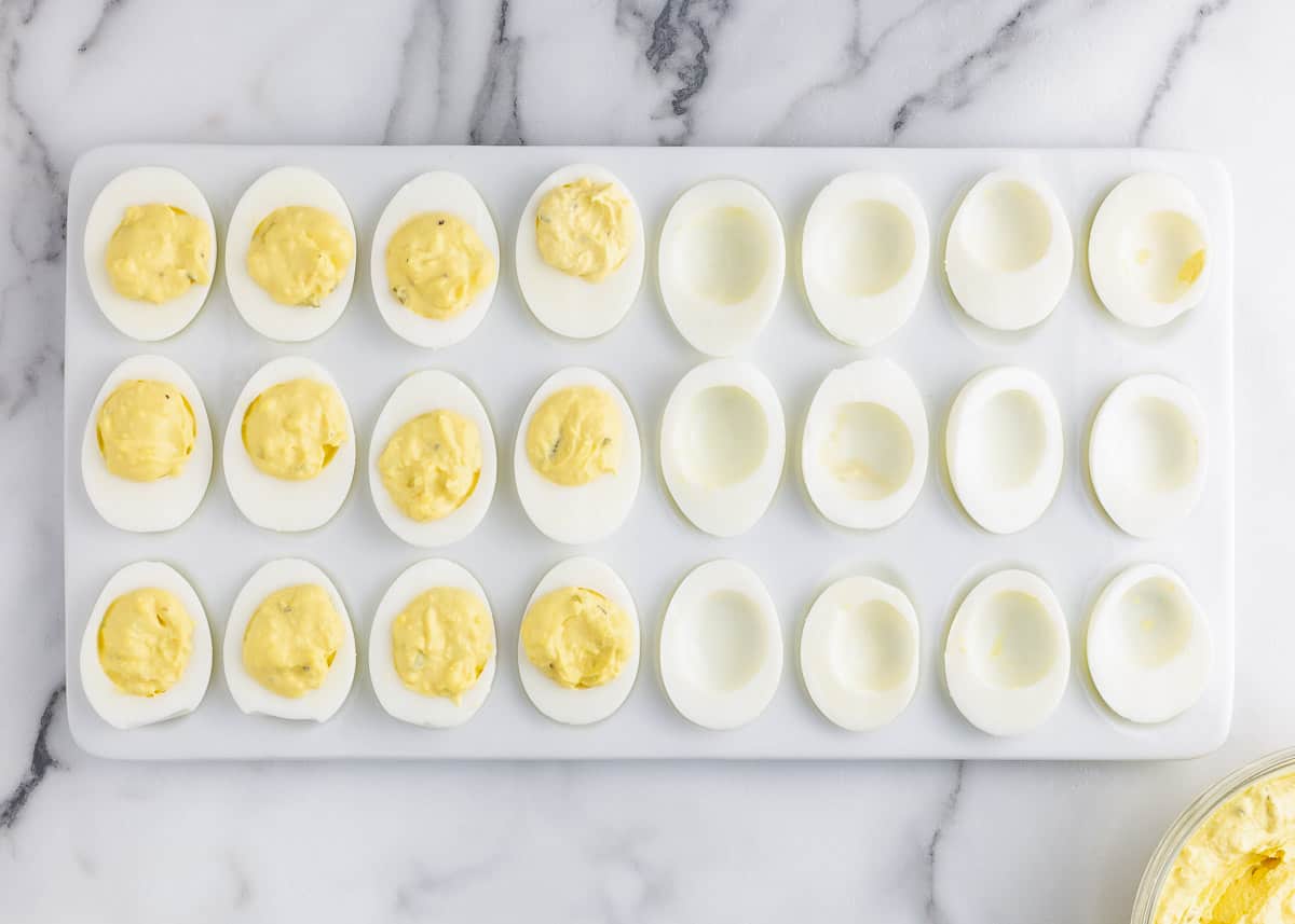 deviled eggs cut in half on white plate