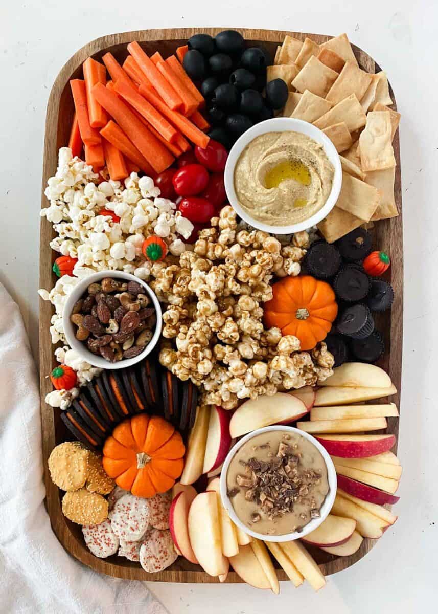 fall charcuterie board with pumpkins