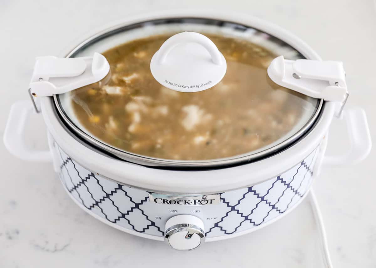 Green enchilada chicken soup in crock pot with lid.