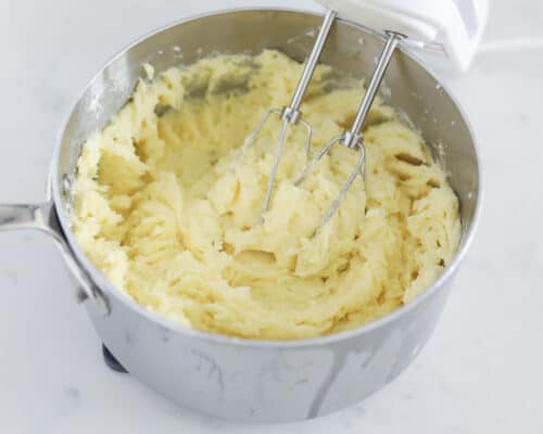 mixing mashed potatoes in pot