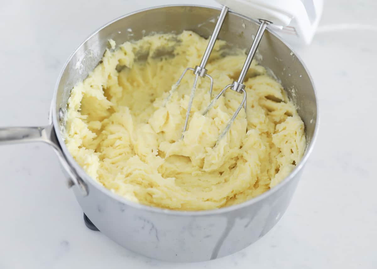 mixing mashed potatoes in pot