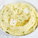 mashed potatoes in white bowl with butter