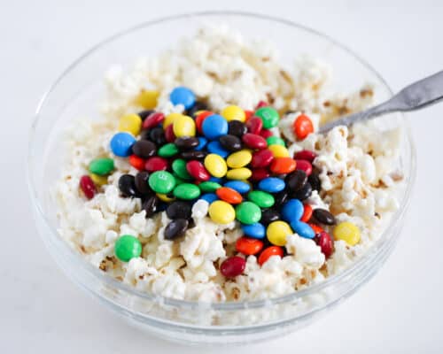 popcorn and m&m's in glass bowl