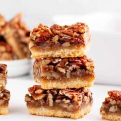 A stack of 3 pieces of pecan pie bars with a shortbread crust.