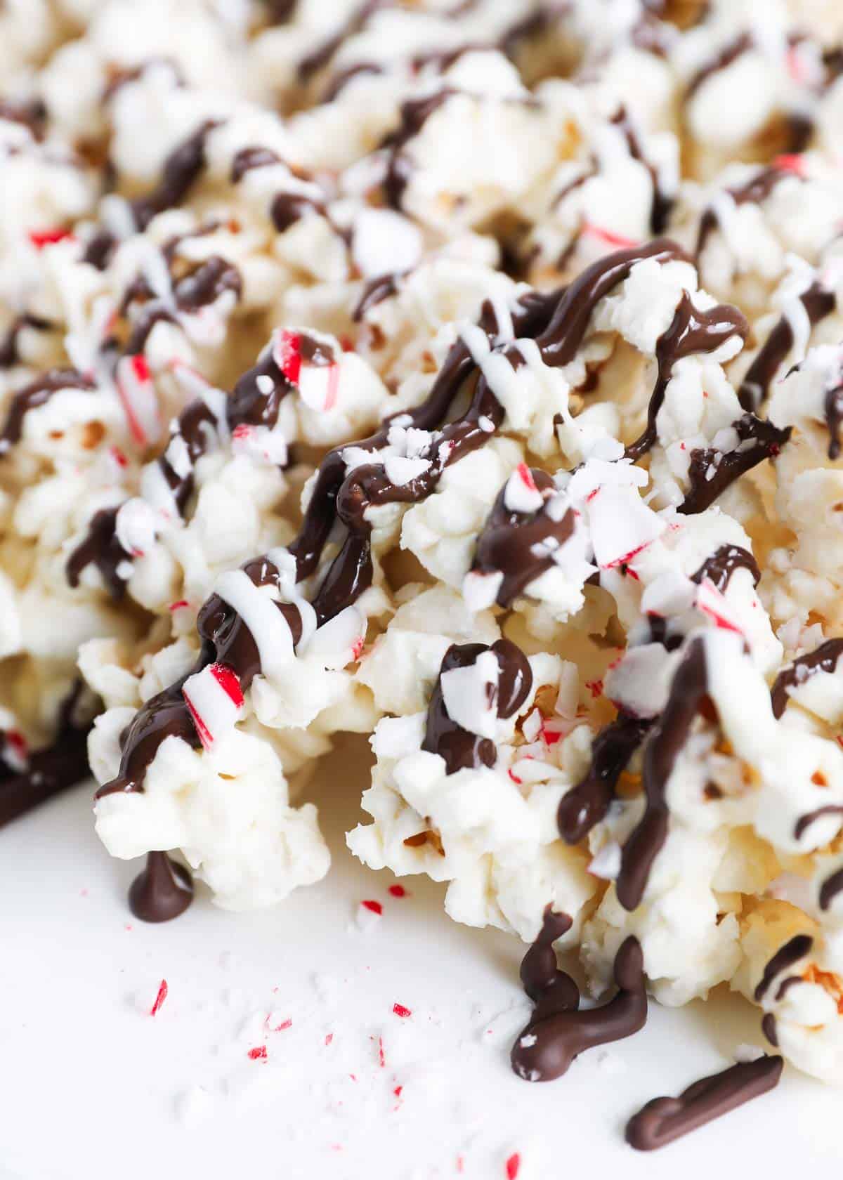 Peppermint bark popcorn with chocolate drizzle.