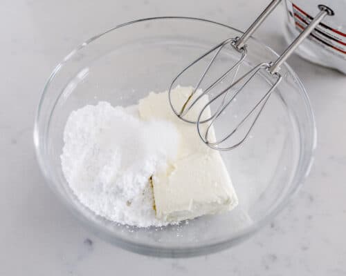 mixing cream cheese and powdered sugar in bowl