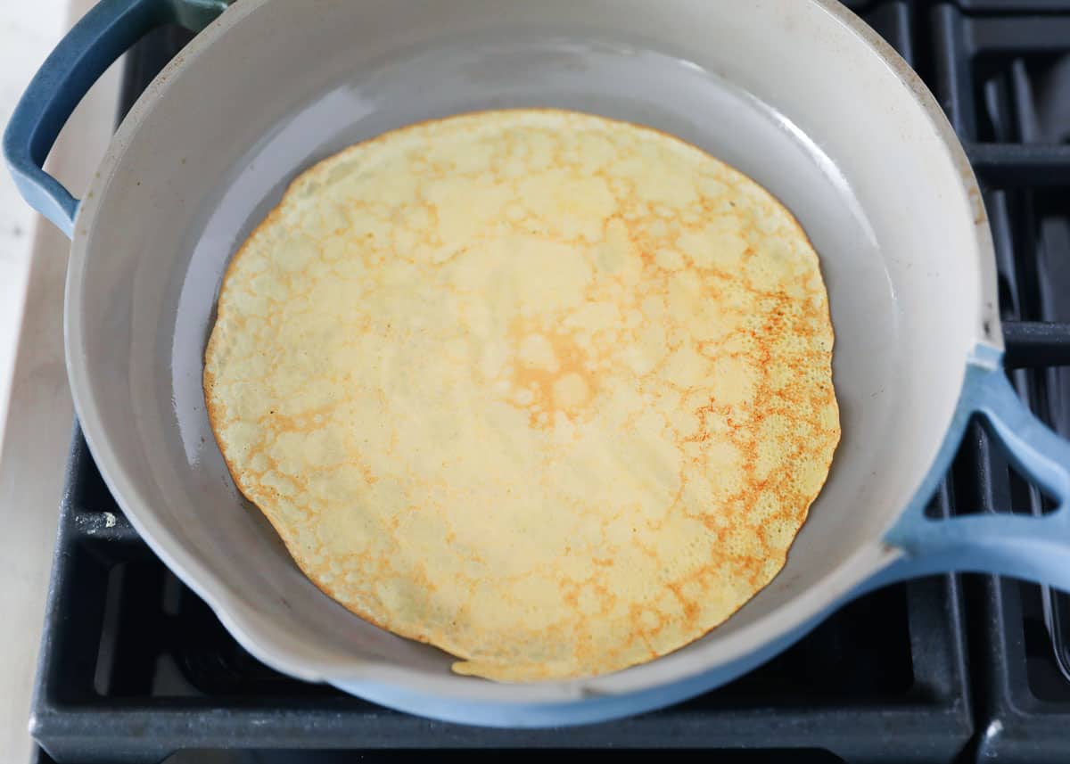 cooking pumpkin crepes in pan