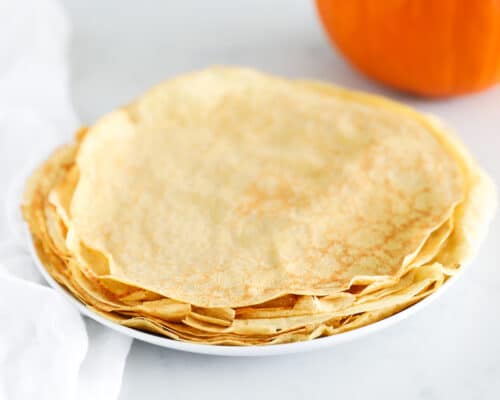 stack of pumpkin crepes on white plate