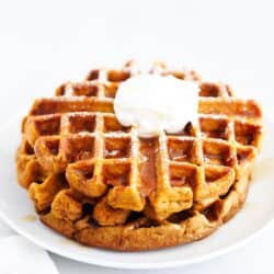 pumpkin waffles stacked on white plate