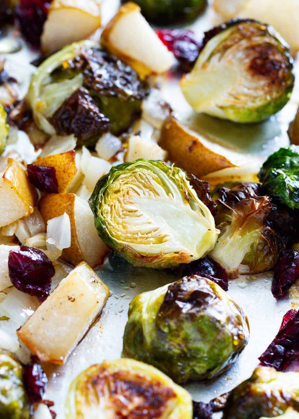 Roasted brussel sprouts with cranberries on pan.