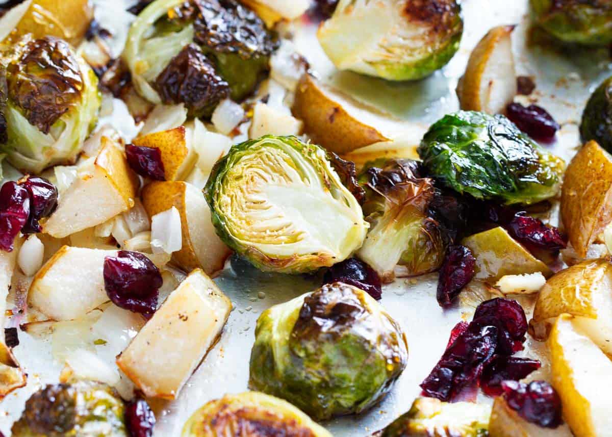 Roasted brussel sprouts with cranberries on pan.