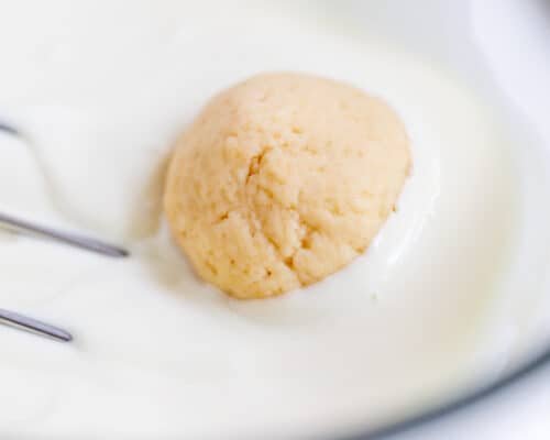 dipping cookie balls in white chocolate