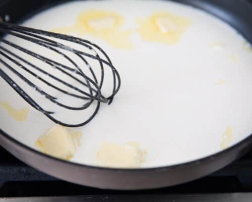 whisking milk and butter in pan