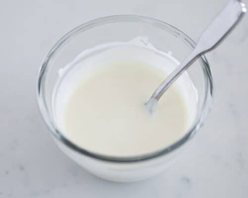 melted white chocolate in glass bowl