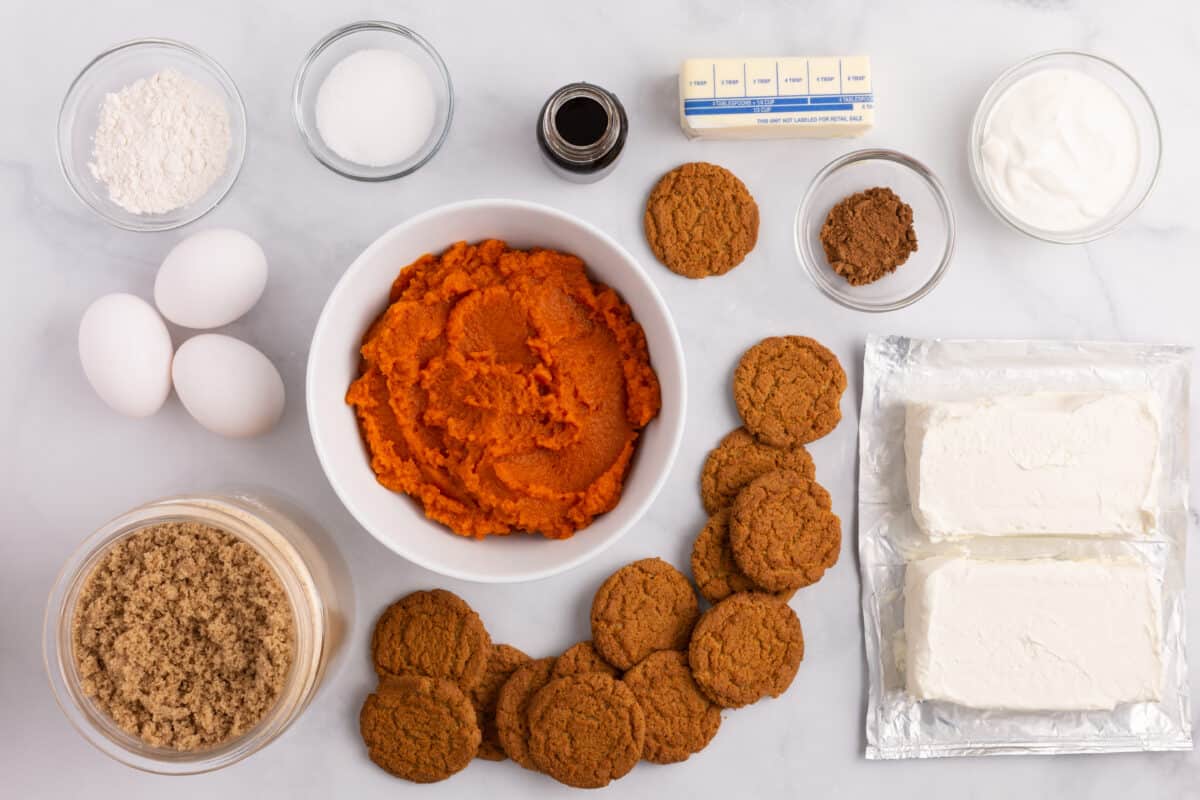 Pumpkin cheesecake ingredients on counter.