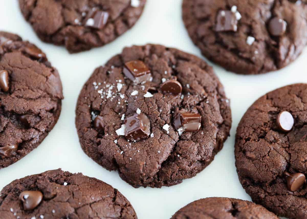 Fudgy Chocolate Brownie Cookies loaded with extra chocolate chips and M&M's. Only requires one bowl and no refrigerating. The perfect easy and delicious cookie for Valentine's Day! Brownie cookies on counter.