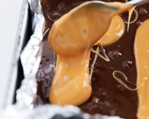 pouring caramel in brownie batter