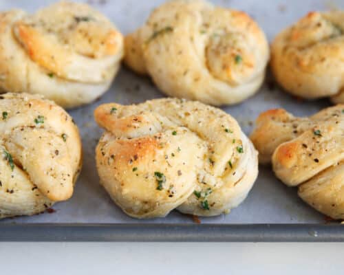 garlic knots on baking sheet