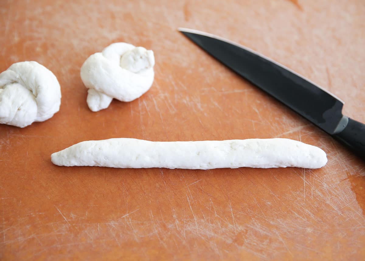 cutting dough on cutting board