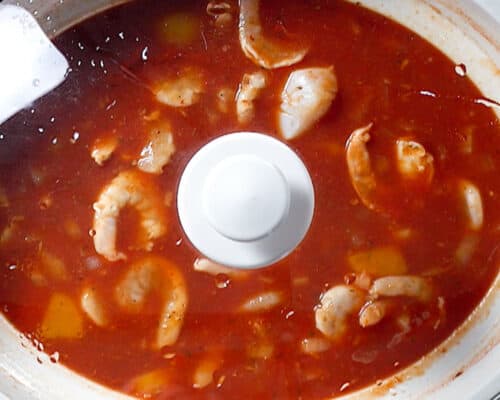 seafood stew in crockpot with lid