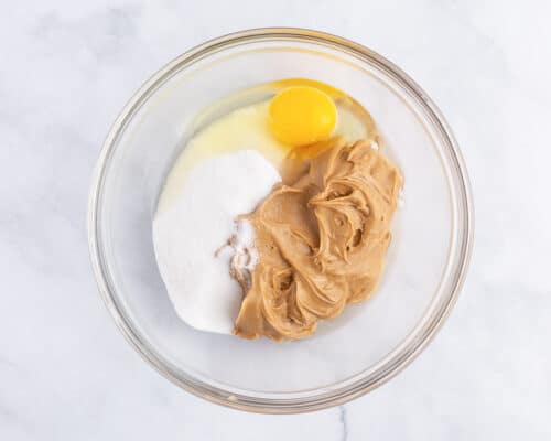 peanut butter, sugar and egg in bowl