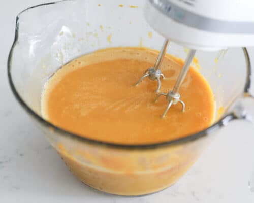 mixing pumpkin batter in bowl