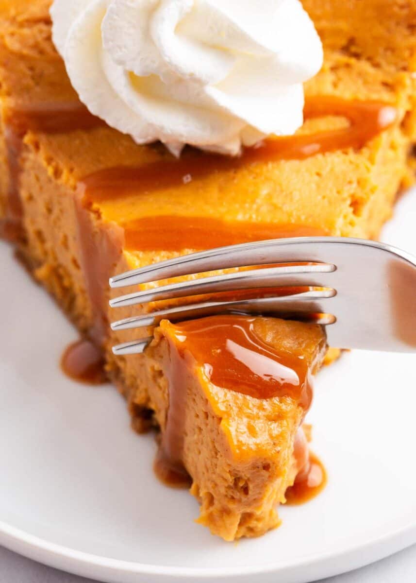 fork taking a piece of pumpkin cheesecake