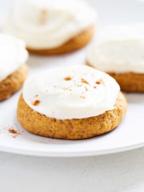 frosted pumpkin cookies with cinnamon on top