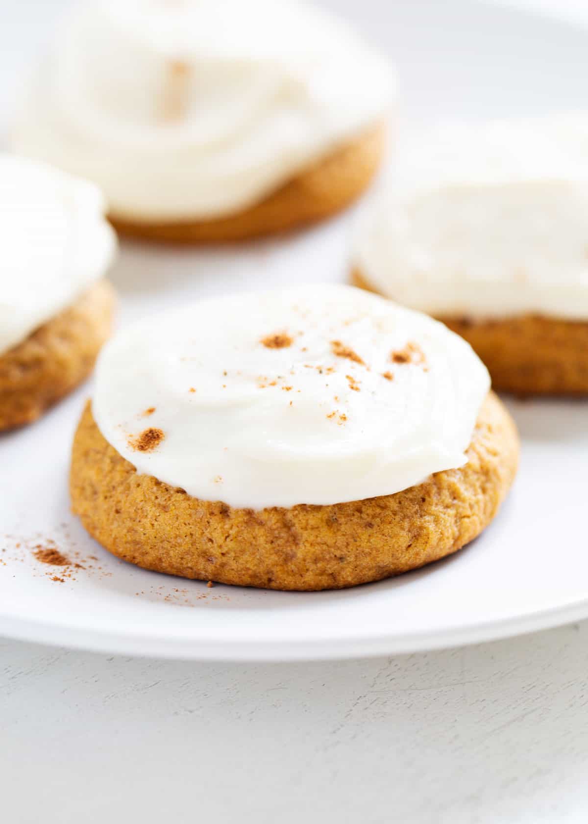 frosted pumpkin cookies with cinnamon on top