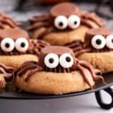 peanut butter spider cookies on black plate