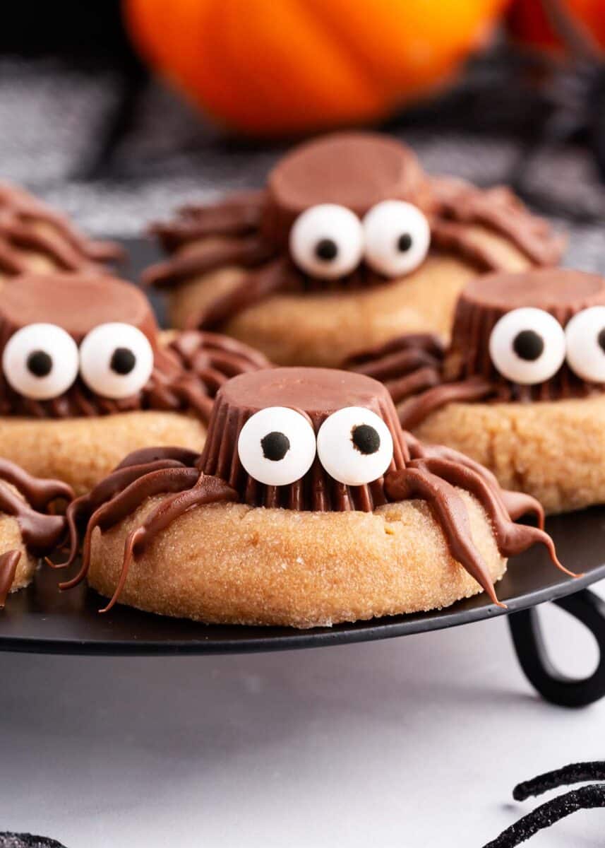 peanut butter spider cookies on black plate