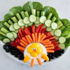 Thanksgiving turkey veggie platter arranged with cucumbers, celery, peppers, carrots, and a turkey-shaped ranch dip.