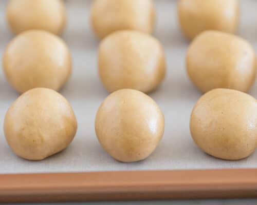 peanut butter balls on baking sheet