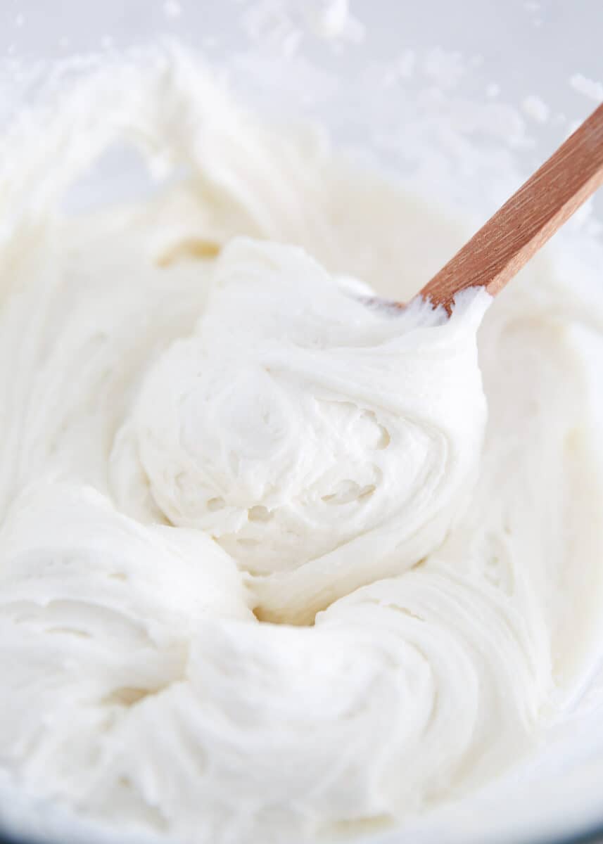 Sour cream frosting in a glass bowl. 