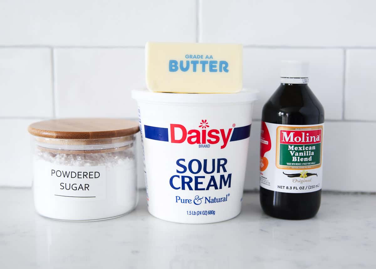 Sour cream frosting ingredients on counter. 