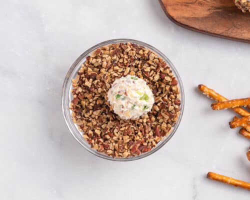 rolling cheeseball in pecans