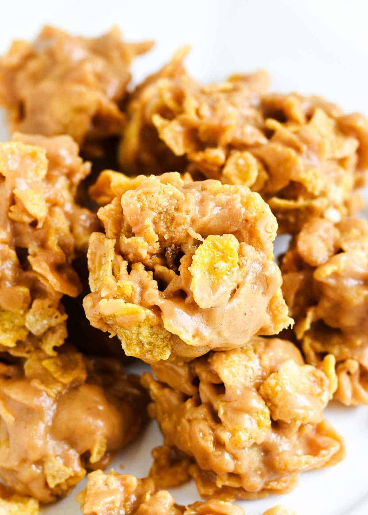 Up close photo of a cluster of Cornflake cookies stacked together. 