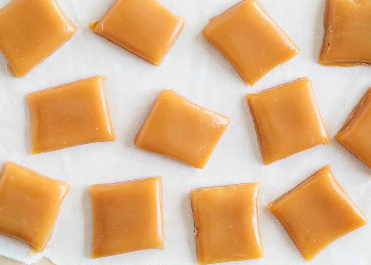Homemade microwave caramels... made in 6 minutes with only 5 ingredients! These will be the easiest candy you will make this holidays! Caramels cut on counter.