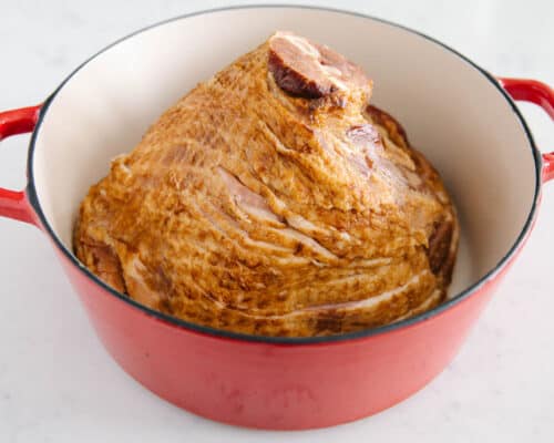 ham placed face down in red pan