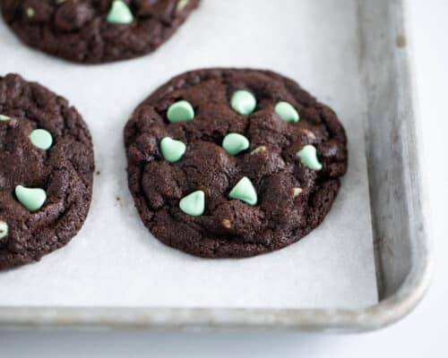 chocolate cookies with mint chips on pan
