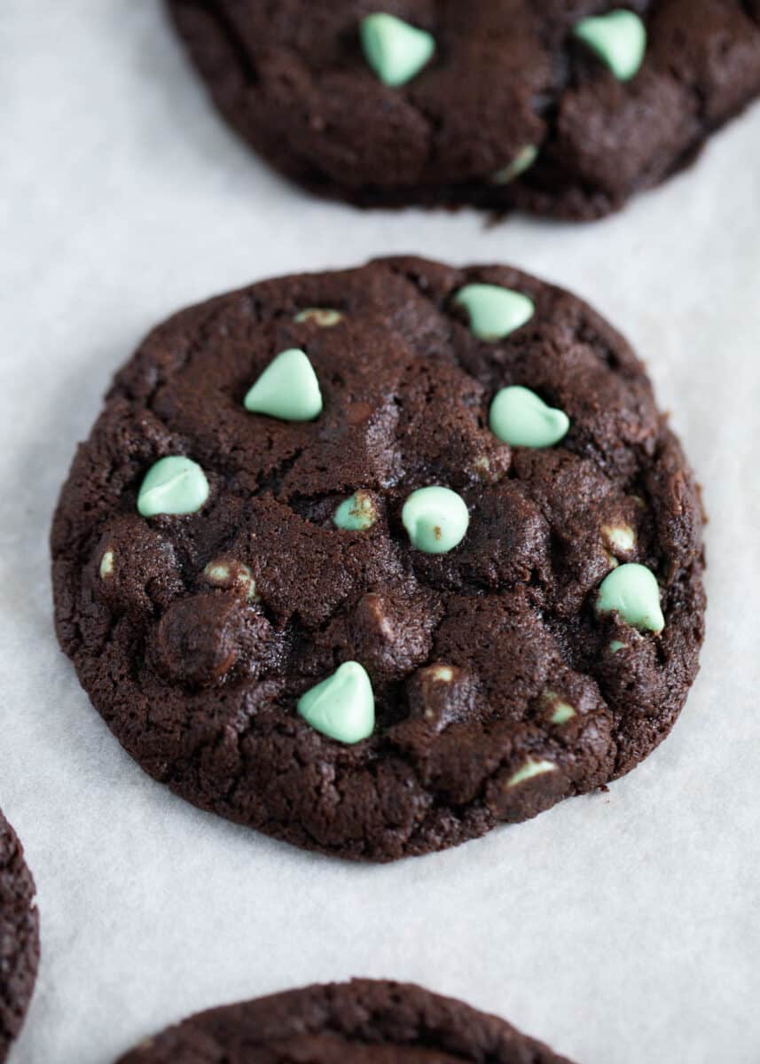 Soft and fudgy chocolate mint cookies made with cake mix. So easy to whip up and have the perfect touch of mint! mint chip chocolate cookie on pan