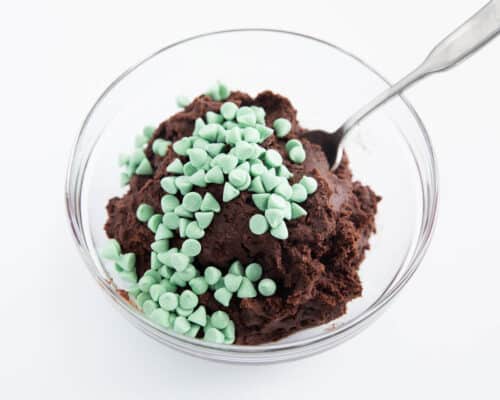 chocolate cookie dough with mint chips in glass bowl