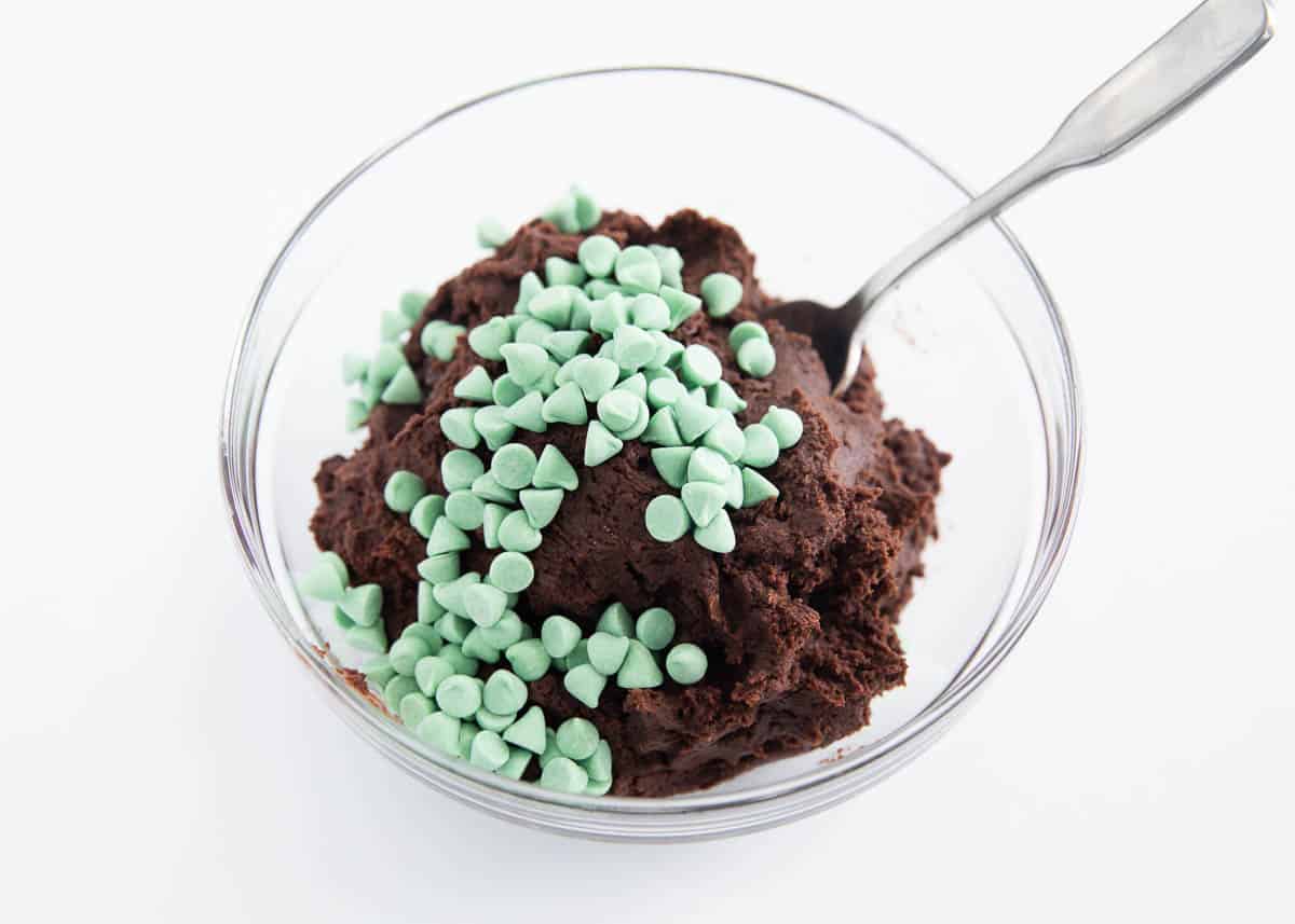 chocolate cookie dough with mint chips in glass bowl