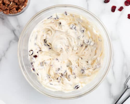 mixed cream cheese and cranberries in bowl